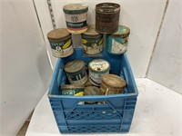 Blue milk crate full of tobacco tins