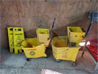 2 mop buckets and wet floor signs