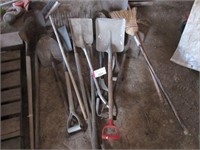 Assortment of shovels, pitch forks, and brooms