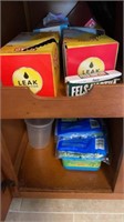 Kitchen cabinet lot - garbage bags, swiffer pads-