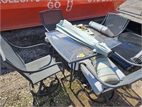 patio table with (4) chairs and an umbrella