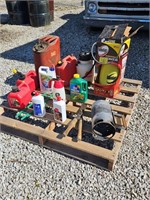 pallet with plastic gas cans, sprayers, charcoal