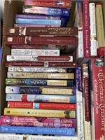 Box of paperback Christmas themed romance books