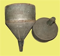 A pair of large galvanized funnels including a