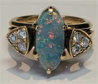 A black opal and diamond ring in 18k gold