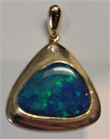 Black opal and diamond pendant in 14k gold