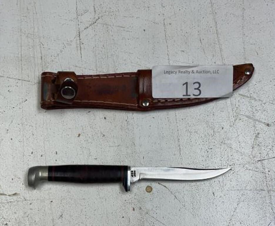 Knife includes sheath