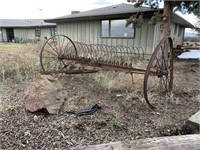 ANTIQUE HAY RAKE IN FRONT OF HOUSE