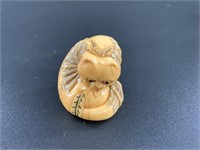 Antique mammoth netsuke of an house cat turned to