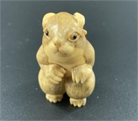 Antique mammoth netsuke of a thoughtful looking ro