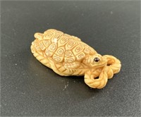 Antique mammoth netsuke of a cute turtle sitting o