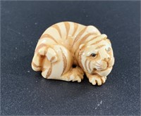 Antique mammoth netsuke of a cute tiger curled up,