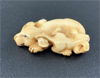 Antique mammoth netsuke of a mother dog and her pu