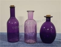 Purple bottles. Some with corks.