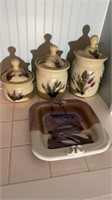 Three handmade pottery canisters with lids, with