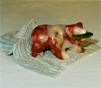 Carved stone bear with green jade fish in his