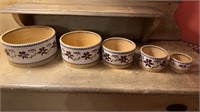 Five graduated mixing bowls, hand painted pottery