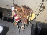 HORSE SADDLE AND SADDLE STAND IN THE BASEMENT