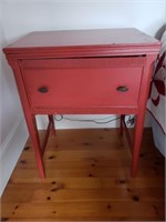 PAINTED RED SEWING CABINET WITH MACHINE INSIDE