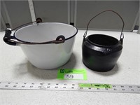 Enamelware pot with wood handle and a cast iron me