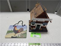 Decorative birdhouse and a ceramic wall plaque