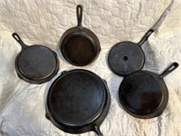 Five cast-iron skillets