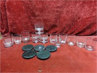 Assorted barware glasses. Marble drink coasters.