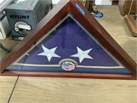 Folded American flag is display case