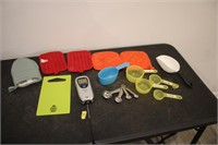 Cutting board, measuring cups, pot holders