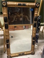 Black and gold framed mirror