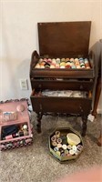 Decorative spool cabinet with sewing supplies.