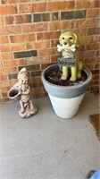 Planter, concrete gnome, and a plastic dog