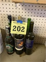 Six green colored wine, bottles, empty