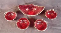 Collection of red glass candy dishes in wire