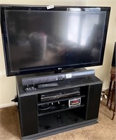 47" LG TV, stand, Sharp sound bar, VCR/DVD, clock
