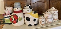 Cookie jars and canisters on top of fridge