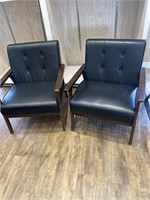 2 black faux leather and wood sitting chairs