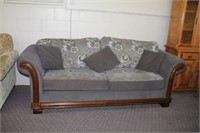 Two cushioned sofa, decorative wood front, some