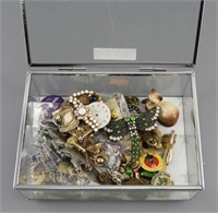 Glass jewelry box of vintage brooches, pins, tie