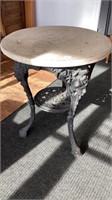 Antique cast iron table with molded beauties on