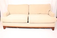 BEIGE COUCH WITH WALNUT FINISHES