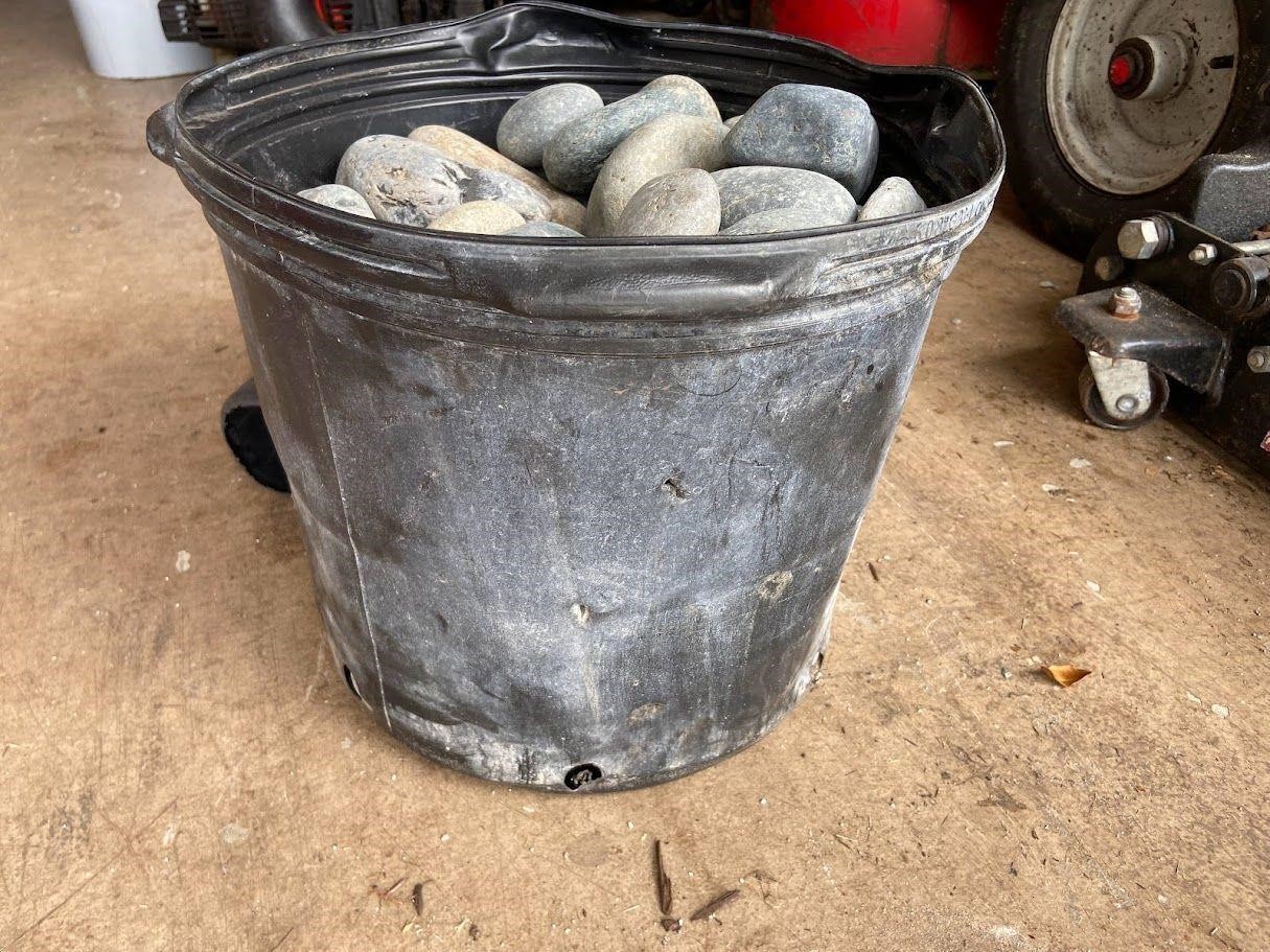 Approx 5 gallon bucket full of round river rocks