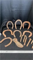 Various horseshoes, spikes,  metal shoe form