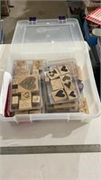 Storage container with various crafting stamps.