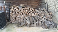 Metal log rack with split firewood, ready to be