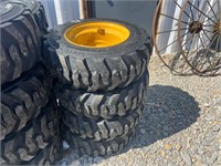 10-16.5 Skid Steer Tires on Yellow Wheels