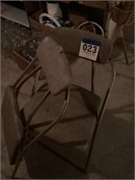 Two folding metal chairs one needs repaired