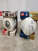 White panel footballs, one is signed by