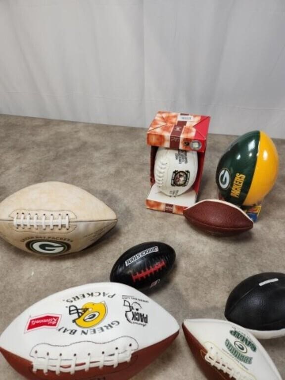 Assortment of Packer footballs