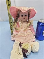 Small porcelain doll with pink dress